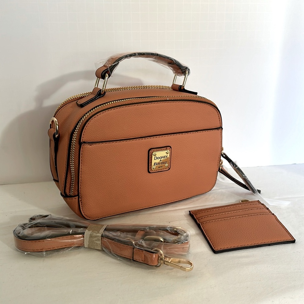 Pumpkin colored cross body purse like new. 7” wide 5” high 3” deep.